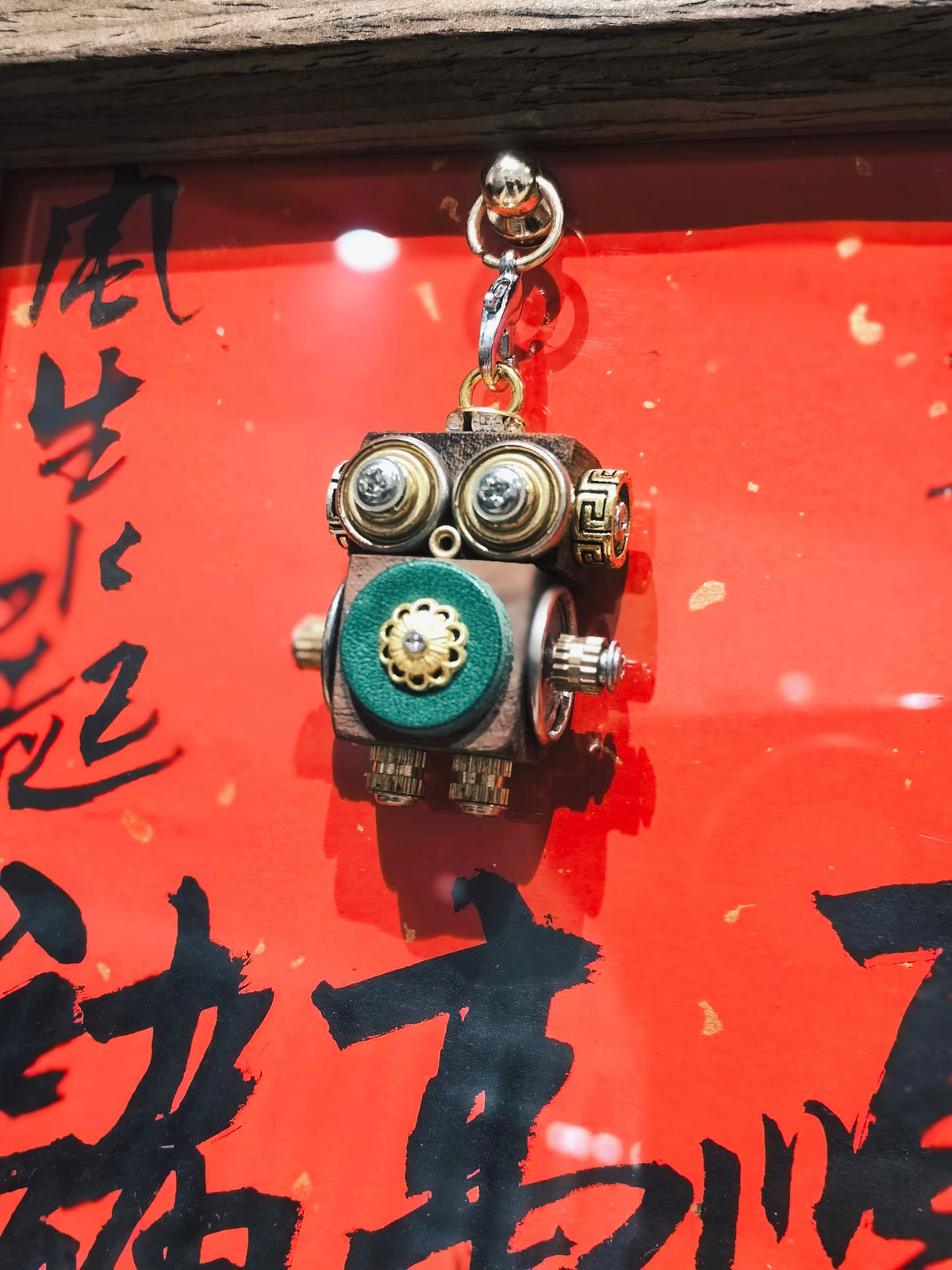 Golden-Eyed Steampunk Robot Pendant with Green Floral Detail