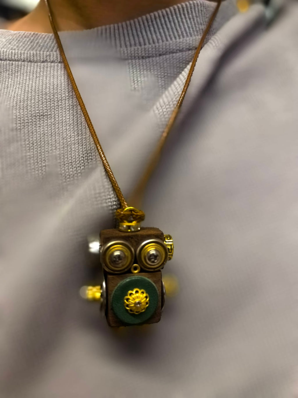 Golden-Eyed Steampunk Robot Pendant with Green Floral Detail